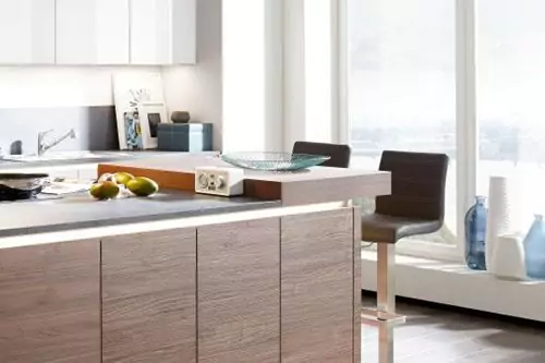 A KITCHEN ISLAND WITH AN INTEGRATED BAR COUNTER