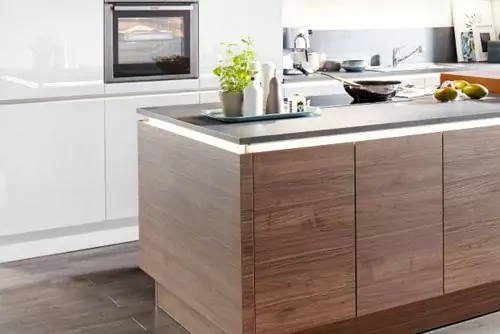 A KITCHEN ISLAND WITH AN INTEGRATED BAR COUNTER