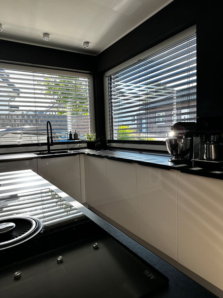 Nolte black and white kitchen with built-in downdraft ventilation